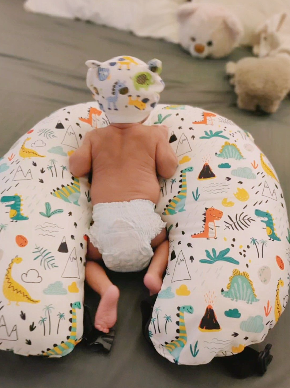 Elegant Cozie Cradle Baby Feeding Pillow in assorted colors, perfect for modern nursery, baby tummy time support