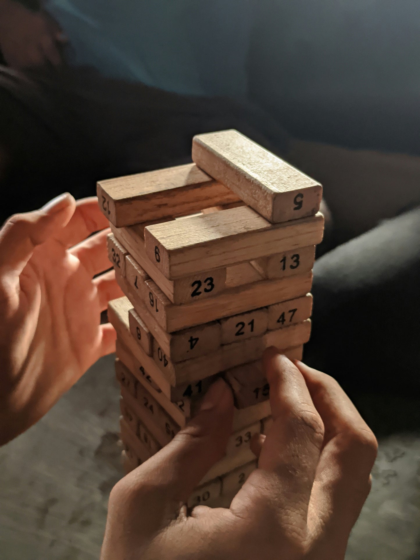 A flat-lay or styled shot of the wooden dice placed next to 3–4 numbered blocks, illustrating the core gameplay mechanic — roll the dice, match the number, pull the block. Use a soft natural backdrop. This image is critical for explaining the product's unique educational twist to buyers who are skimming without reading the description.