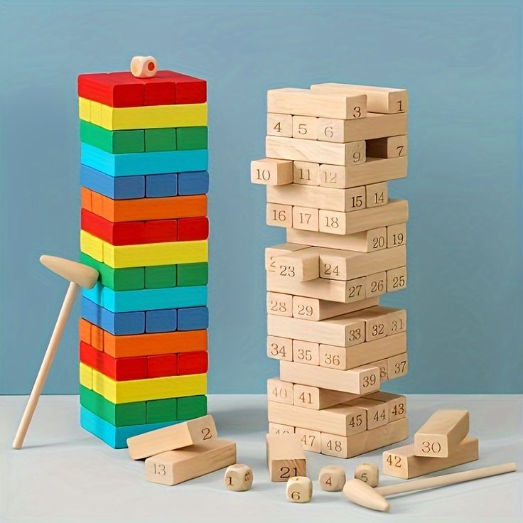 Baby And Fur rainbow wooden blocks standing in a winding domino line on a table, ready to topple.