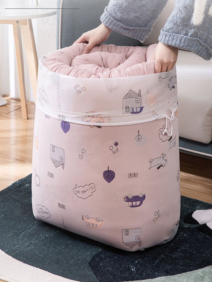 Flat lay of Baby and Fur waterproof round quilt storage bag showing assorted color and design pattern
