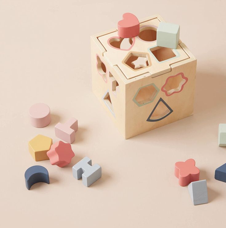 Toddler playing with Baby And Fur shape sorter puzzle box for brain and fine motor skill development
