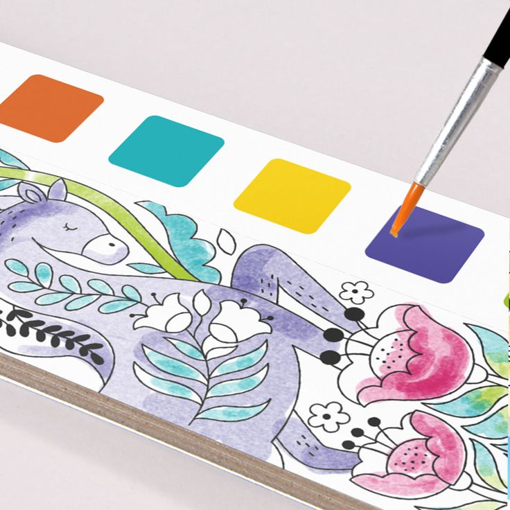 Close-up view of Baby And Fur watercolor paints and brush in kids pocket painting book