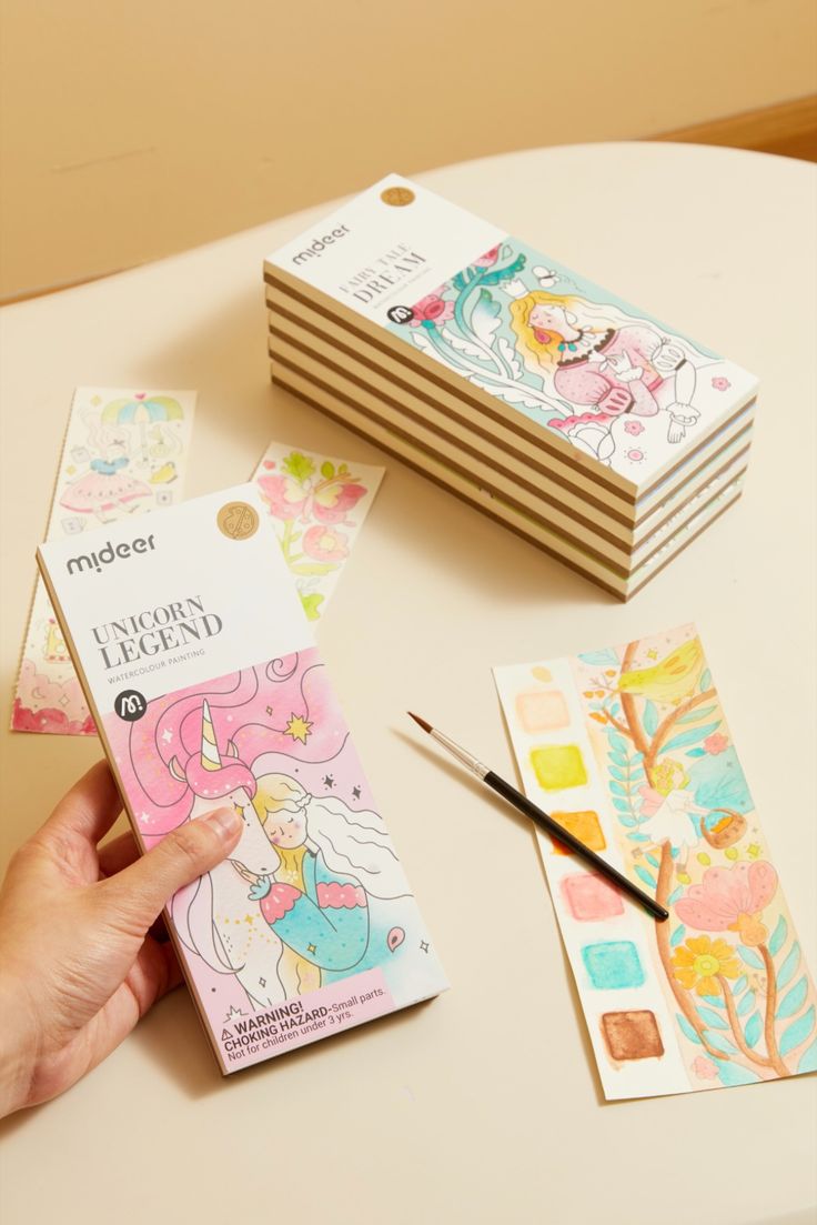 Open view of Baby And Fur watercolor painting book showing palette and paint colors for children